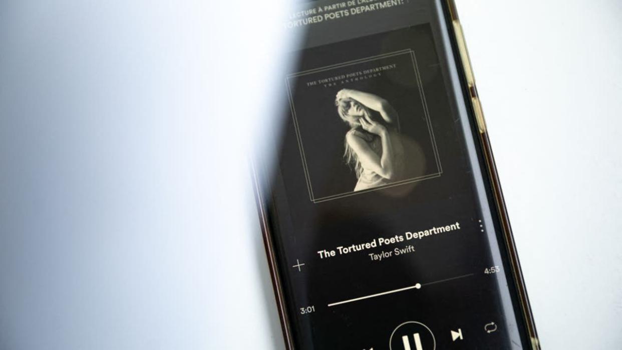 <div>This photograph taken in Paris on April 19, 2024, shows a smatphone displaying the US singer-songwriter Taylor Swift's new album "The Tortured Poets Department" on Spotify. Queen of pop Taylor Swift released her highly anticipated record "The Tortured Poets Department" on April 19, 2024 -- the 11th studio album from the megastar who is already having a blockbuster year. Swift announced the album's release at the Grammys in February, a night that saw the 34-year-old billionaire win a record-breaking fourth Album of the Year prize. (Photo by AFP) (Photo by -/AFP via Getty Images)</div>