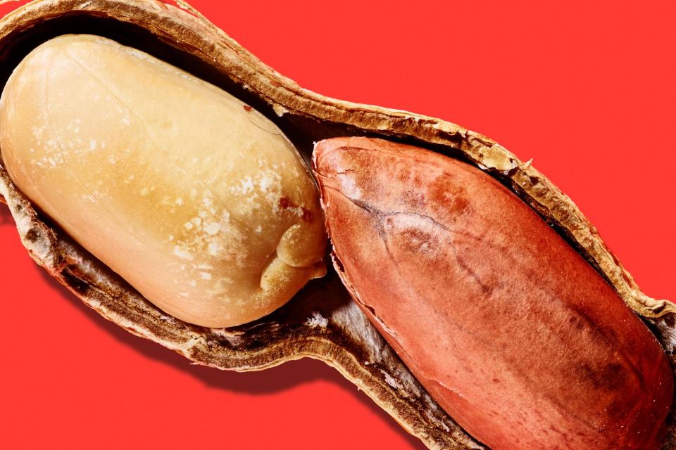 Peanuts in the shell on a red background