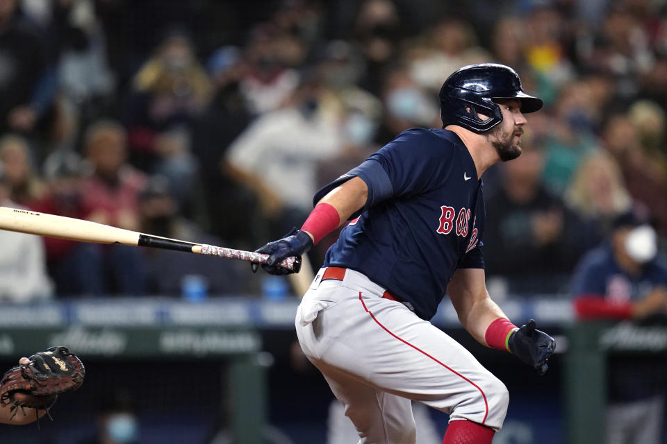 Boston Red Sox's Kyle Schwarber watches his three-run double against the Seattle Mariners during the eighth inning of a baseball game Tuesday, Sept. 14, 2021, in Seattle. (AP Photo/Elaine Thompson)