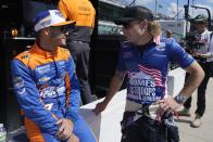 Kyle Larson, left, talks with Santino Ferrucci during qualifications for the Indianapolis 500 auto race at Indianapolis Motor Speedway, Saturday, May 18, 2024, in Indianapolis. (AP Photo/Darron Cummings)