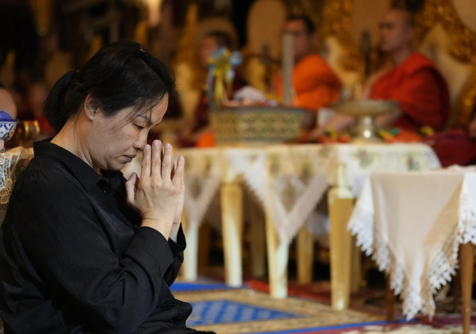 Thanaporn Phromthep pray during a funeral ceremony for her son Duangphet Phromthep at Wat Phra That Doi Wao temple in Chiang Rai, Thailand, Sunday, March 5, 2023. The cremated ashes of Duangphet, one of the 12 boys rescued from a flooded cave in 2018, arrived in the far northern Thai province of Chiang Rai on Saturday where final Buddhist rites for his funeral will be held over the next few days following his death in the U.K. (AP Photo/Sakchai Lalit)
