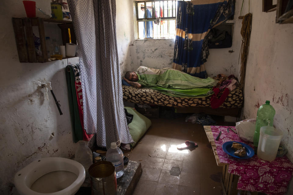 Julio Aguirre, 43, who is serving a sentence for robbery, rests in his cell after attending an evangelical service at the Correctional Institute Model U.1., Dr. Cesar R Tabares, known as Penal Unit 1 in Coronda, Santa Fe province, Argentina, Friday, Nov. 19, 2021. Violating rules against fighting, smoking, using alcohol or drugs can get an inmate kicked out of an evangelical cellblock and back into the normal prison. (AP Photo/Rodrigo Abd)