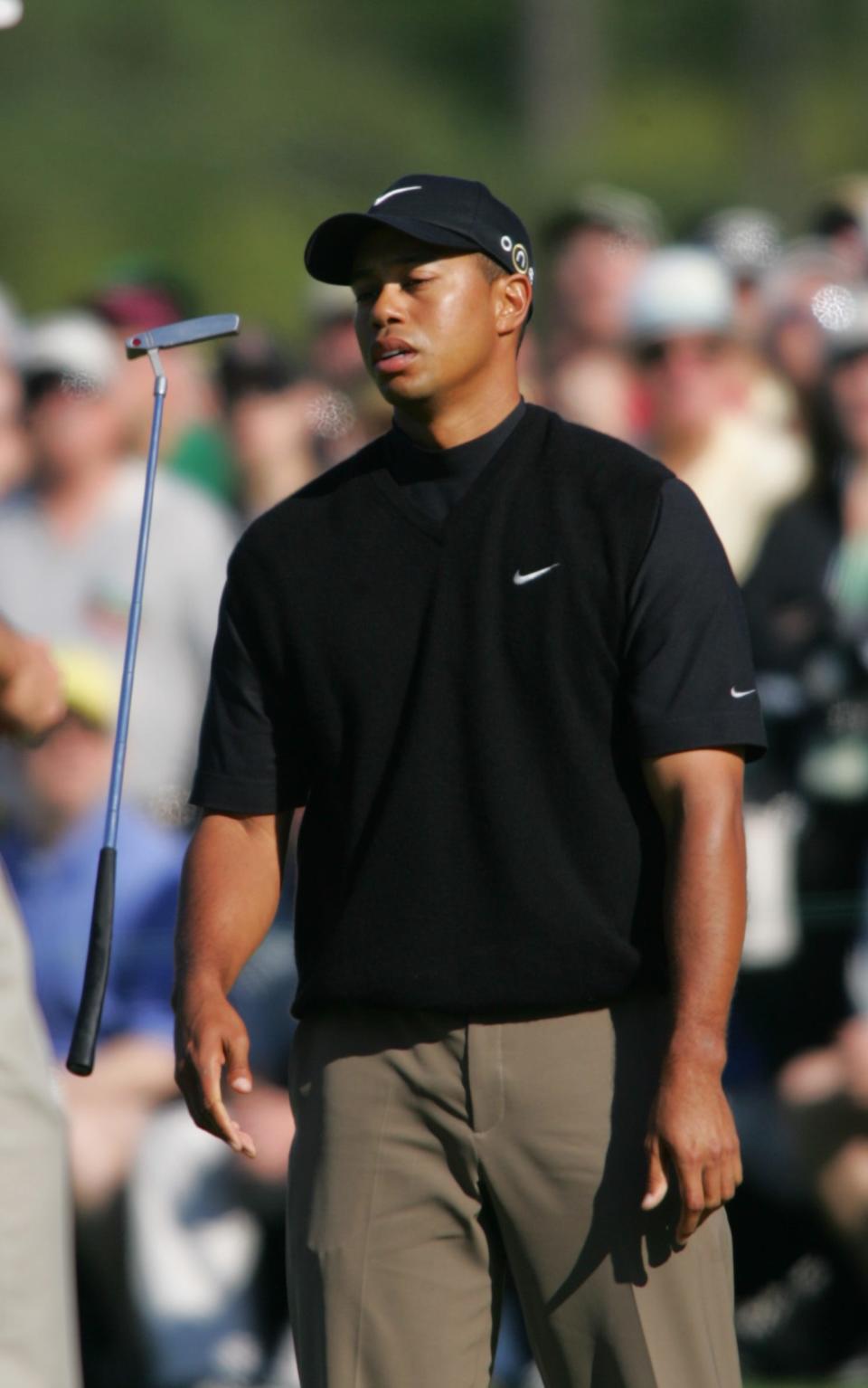 Tiger Woods misses a putt on 17 and throws his putter April 10, 2005. After the third round, completed Sunday morning, Woods was alone in first place by three strokes over Chris DiMarco.
