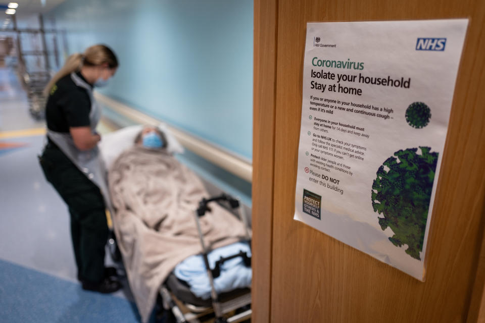 Katie Ffolloitt-Powell of the Patient Transport Services of South Central Ambulance Services speaks to an elderly non-COVID-19 patient as she is moved from hospital to a care home, in Portsmouth, Britain May 5, 2020. Picture taken May 5, 2020. Leon Neal/Pool via REUTERS