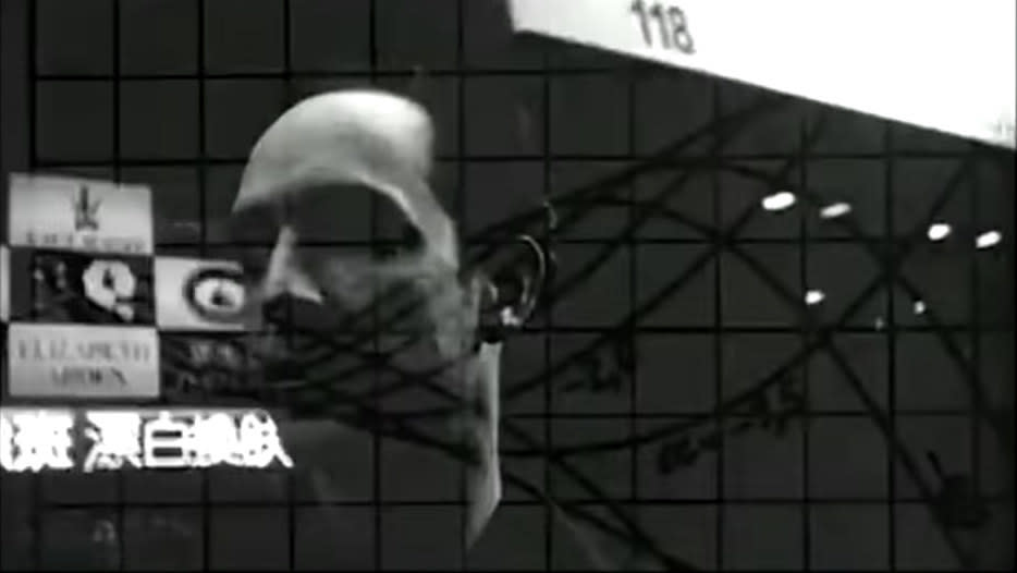 A man in black and white with graphs transposed over his face