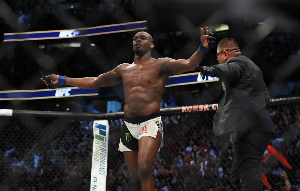 Jon Jones celebrates after knocking out Daniel Cormier in their UFC light heavyweight championship bout during the UFC 214 event at Honda Center on July 29, 2017 in Anaheim, California.