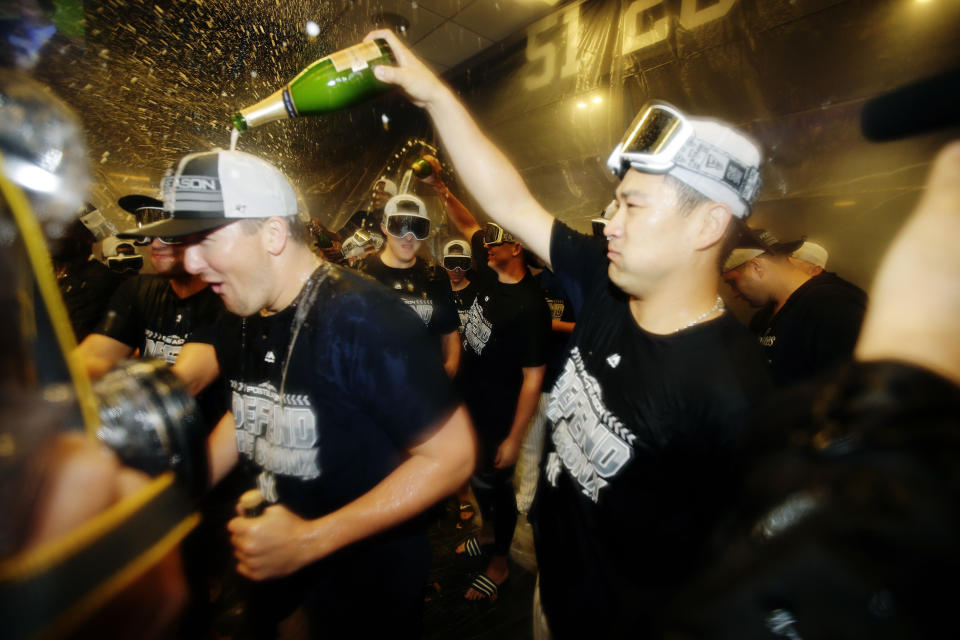New York Yankees' Masahiro Tanaka, right, of Japan, celebrates with teammates after they clinched wildcard playoff birth with a 3-2 win over the Baltimore Orioles in a baseball game Saturday, Sept. 22, 2018, in New York. (AP Photo/Frank Franklin II)