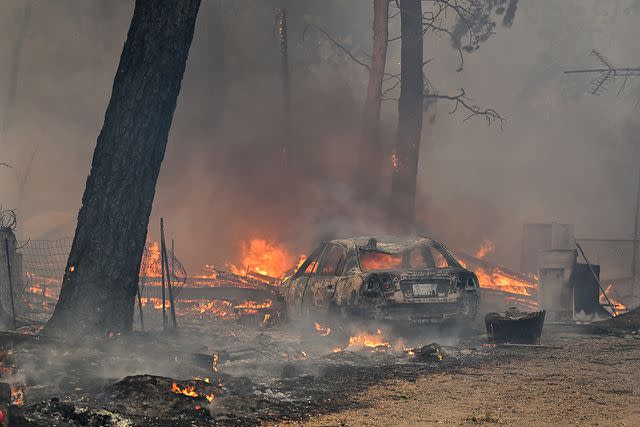 <p>Tayfun Coskun/Anadolu via Getty Images</p> A general view of damaged structure as Park Fire of wildfires continue in Chico, Calif.