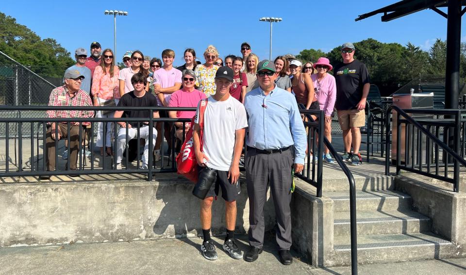 Justin Lyons (bottom left) with Pensacola Catholic coach Geoff Watts (bottom right), and family and friends after fighting off three match points to beat UF’s Borys Zgola 6-1, 4-6, 11-9 (tiebreaker) in the Wild Card round of the Pensacola Futures on Thursday.
