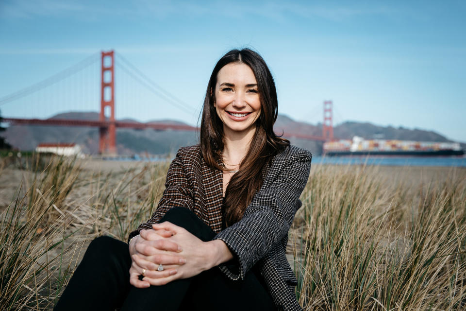 Blaine sitting in grass infront of the The Golden Gate Bridge