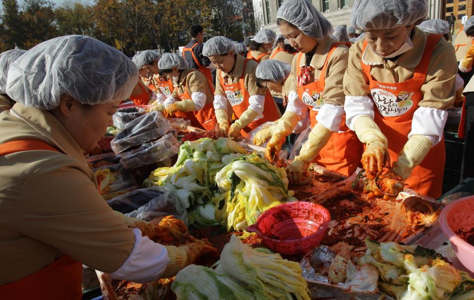 SEOUL, SOUTH KOREA - NOVEMBER 15: More than two thousands of housewives make Kimchi for donation to the poor in preparation for winter in front of City Hall on November 15, 2012 in Seoul, South Korea. Kimchi is a traditional Korean dish of fermented vegetables usually mixed with chili and eaten with rice or served as a side dish to a main meal. (Photo by Chung Sung-Jun/Getty Images)