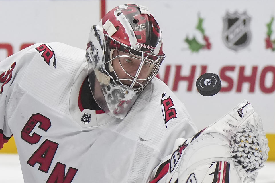 Carolina Hurricanes goalie Antti Raanta makes a glove save against the Vancouver Canucks during the second period of an NHL hockey game Saturday, Dec. 9, 2023, in Vancouver, British Columbia. (Darryl Dyck/The Canadian Press via AP)