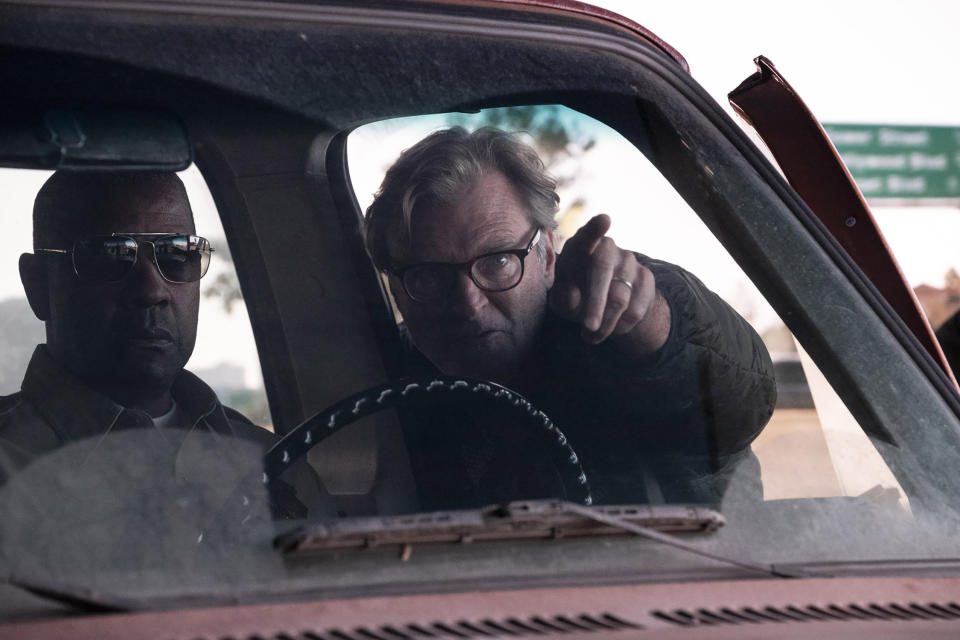 This image released by Warner Bros. Pictures shows actor Denzel Washington, left, and director/writer/producer John Lee Hancock on the set of "The Little Things." (Nicola Goode/Warner Bros. Pictures via AP)