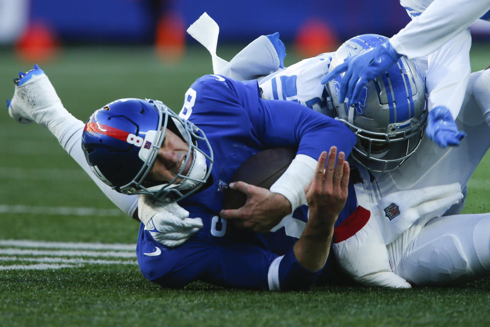 New York Giants quarterback Daniel Jones (8) is sacked by Detroit Lions linebacker Austin Bryant (2) during the second half of an NFL football game, Sunday, Nov. 20, 2022, in East Rutherford, N.J. (AP Photo/John Munson)