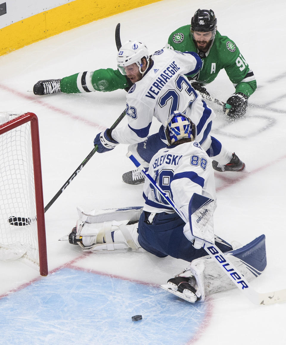 Dallas Stars' Tyler Seguin (91) gets the puck past Tampa Bay Lightning center Carter Verhaeghe (23) and goaltender Andrei Vasilevskiy (88), but does not score during the second period of Game 4 of the NHL hockey Stanley Cup Final, Friday, Sept. 25, 2020, in Edmonton, Alberta. (Jason Franson/The Canadian Press via AP)