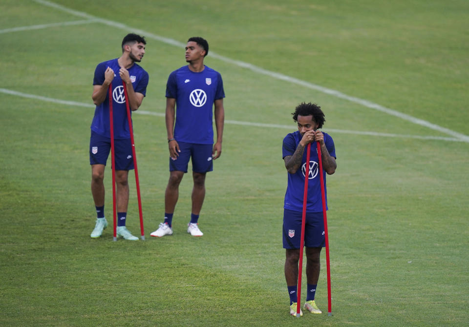 United States' Gianluca Busio, bottom, pauses during a training session ahead of the World Cup 2022 qualifying soccer match against Jamaica in Kingston, Monday, Nov. 15, 2021.(AP Photo/Fernando Llano)