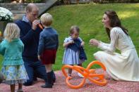 Prince William blows up a balloon as he and his wife Kate, the Duchess of Cambridge, take part in a tea party with their children, Prince George and Princess Charlotte, at Government House in Victoria, Thursday, Sept. 29, 2016. THE CANADIAN PRESS/Jonathan Hayward