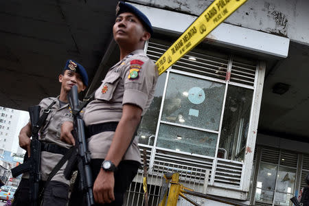 Police stand guard outside the Kampung Melayu bus terminal, the site of suicide bombings, in Jakarta, Indonesia May 25, 2017 in this photo taken by Antara Foto. Picture taken May 25, 2017. Antara Foto/Puspa Perwitasari via REUTERS