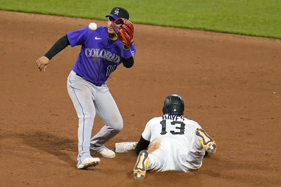 Colorado Rockies shortstop Jose Iglesias (11) takes a late throw from catcher Elias Diaz (not shown) as Pittsburgh Pirates' Ke'Bryan Hayes, right, slides safely into second with a stolen base during the eighth inning of a baseball game in Pittsburgh, Monday, May 23, 2022. (AP Photo/Gene J. Puskar)