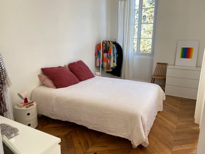 Neatly made bed in eclectic bedroom.