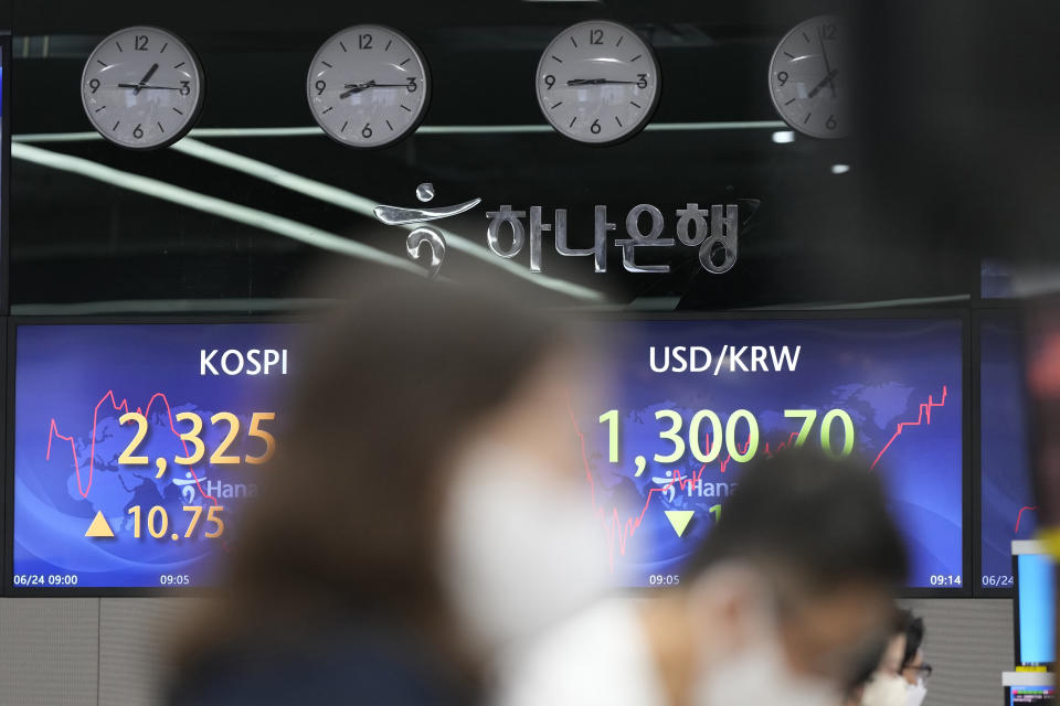 Currency traders watch computer monitors near the screens showing the Korea Composite Stock Price Index (KOSPI), left, and the foreign exchange rate between U.S. dollar and South Korean won at a foreign exchange dealing room in Seoul, South Korea, Friday, June 24, 2022. Shares were higher in Asia on Friday, tracking gains on Wall Street, where the market is headed for its first weekly gain after three weeks of punishing losses. (AP Photo/Lee Jin-man)