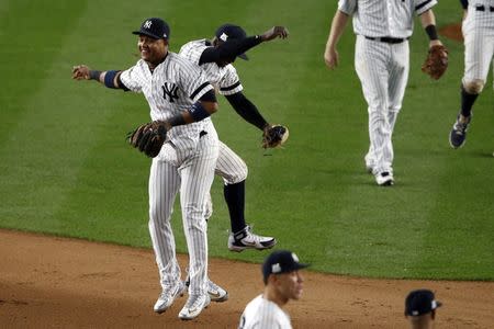 Oct 16, 2017; Bronx, NY, USA; New York Yankees second baseman Starlin Castro (14) and New York Yankees shortstop Didi Gregorius (18) after beating the Houston Astros during game three of the 2017 ALCS playoff baseball series at Yankee Stadium. Mandatory Credit: Adam Hunger-USA TODAY Sports