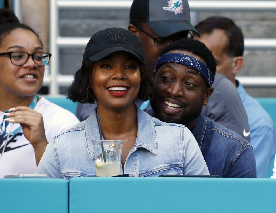 FILE - In this Sunday, Oct. 14, 2018 file photo, Miami Heat player Dwyane Wade and his wife Gabrielle Union-Wade acknowledge the cheers from the crowd during the second half of an NFL football game between the Miami Dolphins and the Chicago Bears in Miami Gardens, Fla. Miami Heat star Dwyane Wade and his wife Gabrielle Union-Wade have a baby. The couple on Thursday, Nov. 8, 2018 announced they’ve welcomed a baby girl into the world. (AP Photo/Joel Auerbach, File)