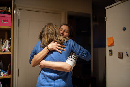 Berwyn, a neighbour of Maria and Adi who moved to the UK in the 1980s from Australia, says goodbye to Maria after a visit at her home in London, Britain, February 19, 2019. REUTERS/Alecsandra Dragoi