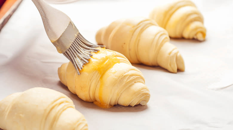 Pastry brush on croissants