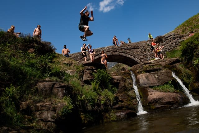 People enjoying the good weather by Three Shires Head on the River Dane, where Cheshire, Derbyshire and Staffordshire meet (Jacob King/PA)