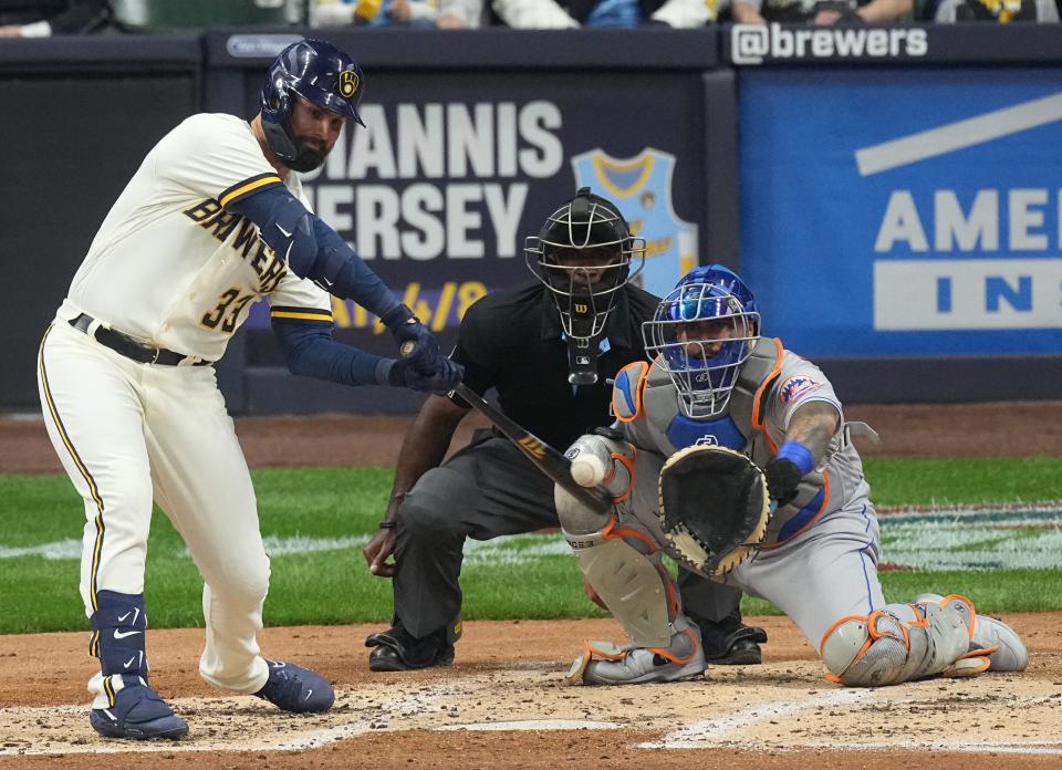 Milwaukee Brewers left fielder Jesse Winker (33) hits an RBI single during the third inning of their game against the New York Mets Monday, April 3, 2023 at American Family Field in Milwaukee, Wis.