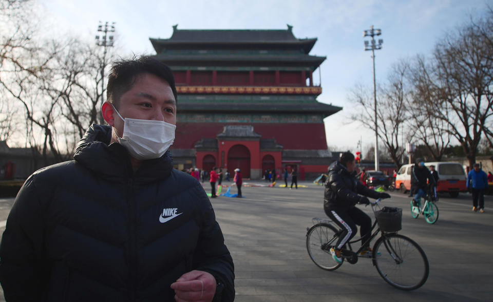 Jia Pei, 30, speaks during an interview about air quality next to the Drum Tower in Beijing on Monday, Feb. 7, 2021. He said the air in Beijing used to feel like "inhaling dust" because of industrial pollution but that "it's a lot better now." (AP Photo/Sam McNeil)