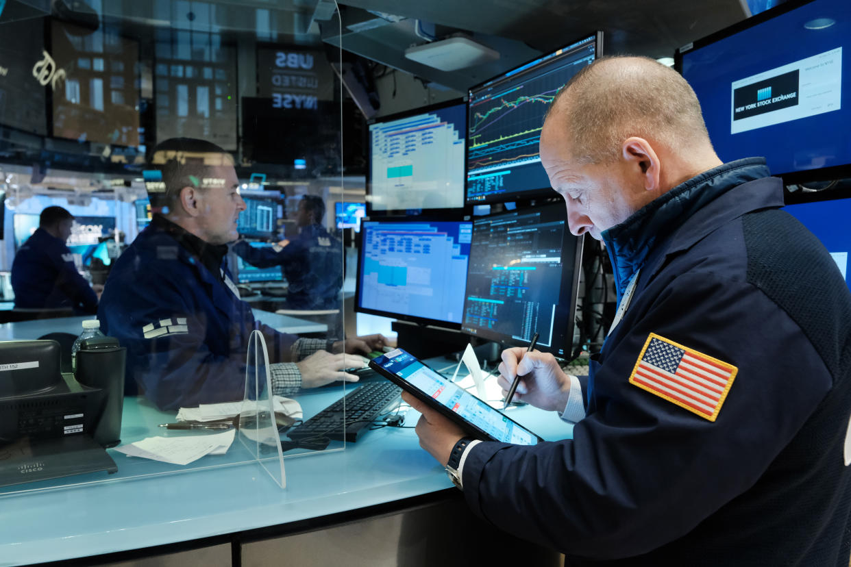 NEW YORK, NEW YORK - NOVEMBER 29: A trader works on the floor of the New York Stock Exchange (NYSE) at the start of trading on Monday following Friday’s steep decline in global stocks over fears of the new omicron Covid variant discovered in South Africa on November 29, 2021 in New York City. Stocks surged in morning trading as investors get more data on the new variant and reports that symptoms have so far been mild for those who have contracted it.  (Photo by Spencer Platt/Getty Images)