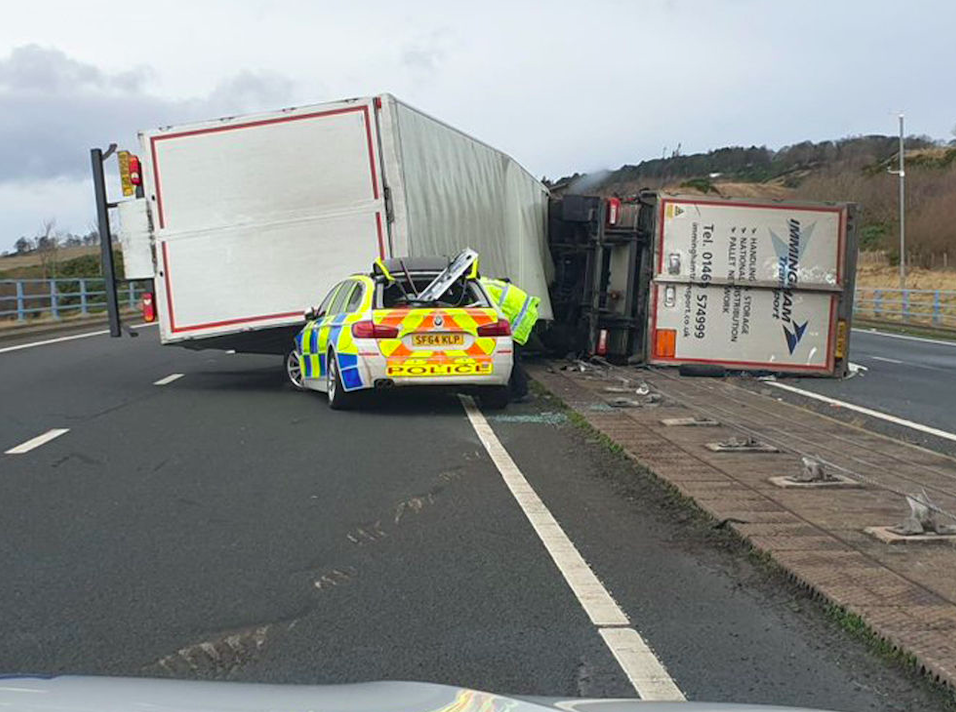 A lorry toppled onto a police car in Scotland during high winds (PA)