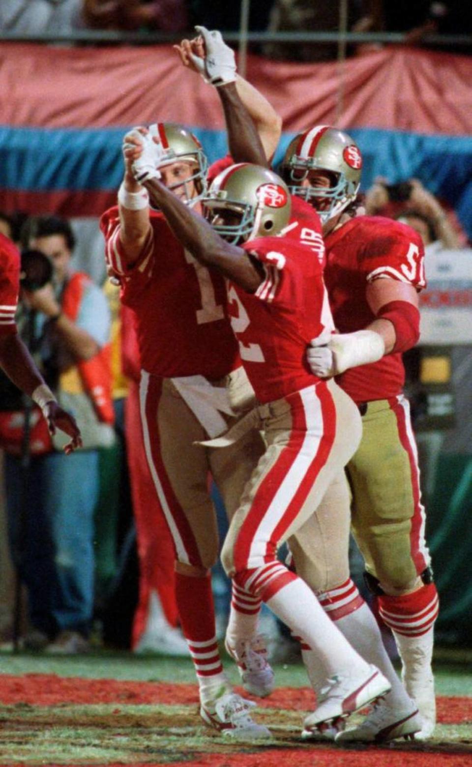 San Francisco 49ers wide receiver John Taylor celebrates the game-winning touchdown with quarterback Joe Montana in the last minute of Super Bowl XXIII.