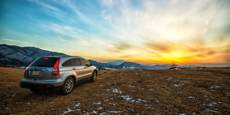 a car leaving into the sunset