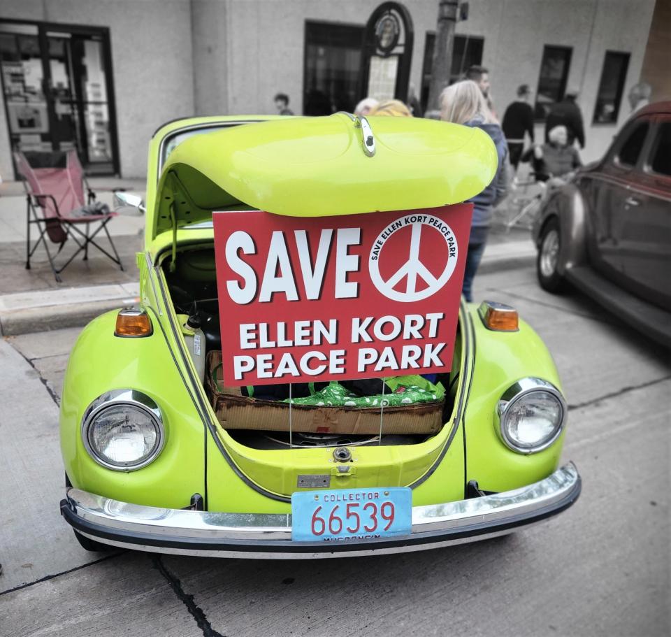 Opponents of the Trout Museum's proposal to relocate to Ellen Kort Peace Park make a statement during Appleton's License to Cruise car show.