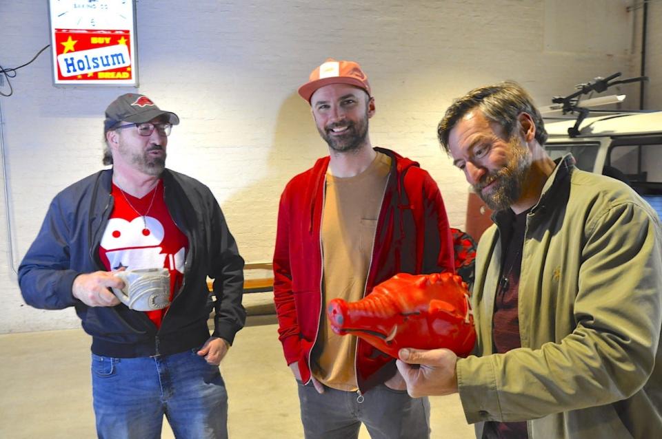 Brandon Chase Goldsmith, left, Adam Harbottle, and Rham Cunningham, holding the Hog hat, It will be all about the Hogs Thursday, March 23, 2023 in the Bakery District where a film series has been bumped back a week for the Sweet Sixteen game to be shown on the big screen in Fort Smith for a watch party. Arkansas takes on Connecticut at 6:15 p.m.