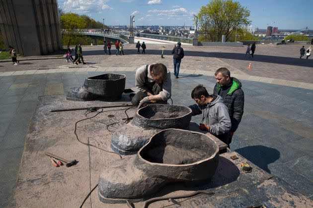 Unos obreros retiran las ultimas piezas de una estatua conmemorativa entre Ucrania y Rusia, en Kiev (Ucrania).&#xa0; (Photo: MIGUEL GUTI&#xc9;RREZ / EFE)