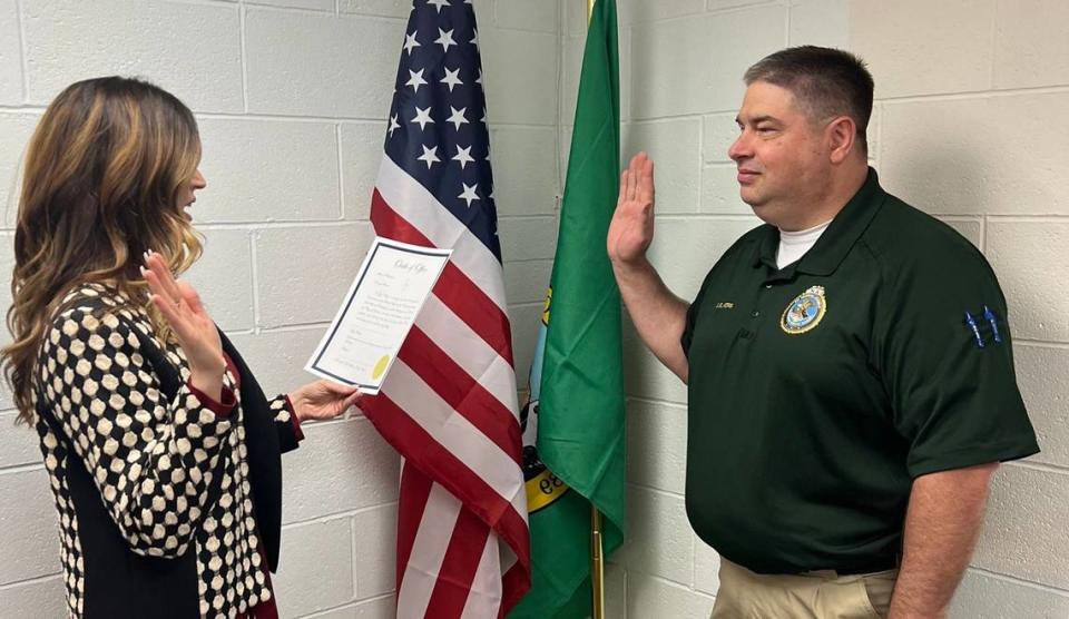 Prosser City Clerk Rachel Shaw administers the Oath of Office to Police Chief Jay King.
