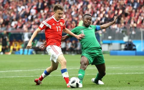 Aleksandr Golovin of Russia is challenged fairly in the area by Osama Hawsawi of Saudi Arabia - Credit: Ryan Pierse/Getty Images