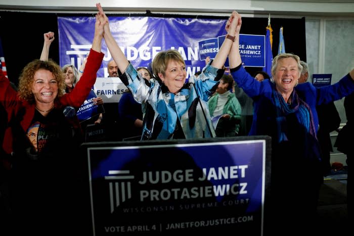 Janet Protasiewicz celebrates alongside Wisconsin Supreme Court Justices Rebecca Dallet and Ann Walsh Bradley at her election night watch party in Milwaukee, Wisconsin, after the race was called in her favor.