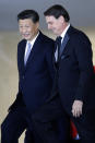 China's President Xi Jinping, left, walks with the Brazil's President Jair Bolsonaro, upon Xi Jinping's arrival for a bilateral meeting on the sidelines of the 11th edition of the BRICS Summit, at the Itamaraty Palace, in Brasília, Brazil, Wednesday, Nov. 13, 2019. (AP Photo/Eraldo Peres)