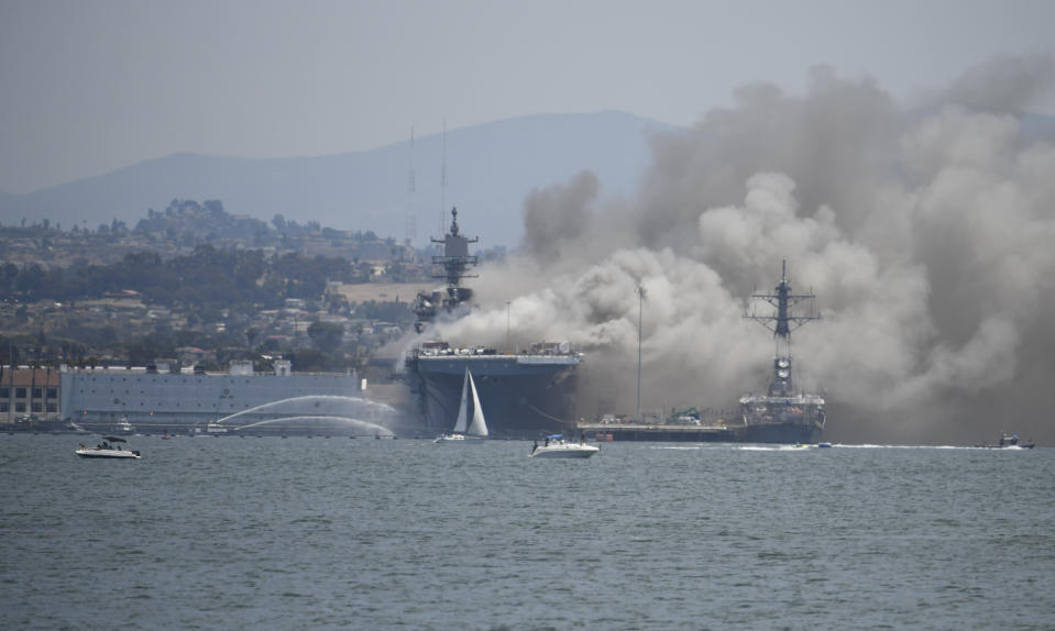 Smoke rises from the USS Bonhomme Richard at Naval Base San Diego Sunday, July 12, 2020, in San Diego after an explosion and fire Sunday on board the ship at Naval Base San Diego. (AP Photo/Denis Poroy)