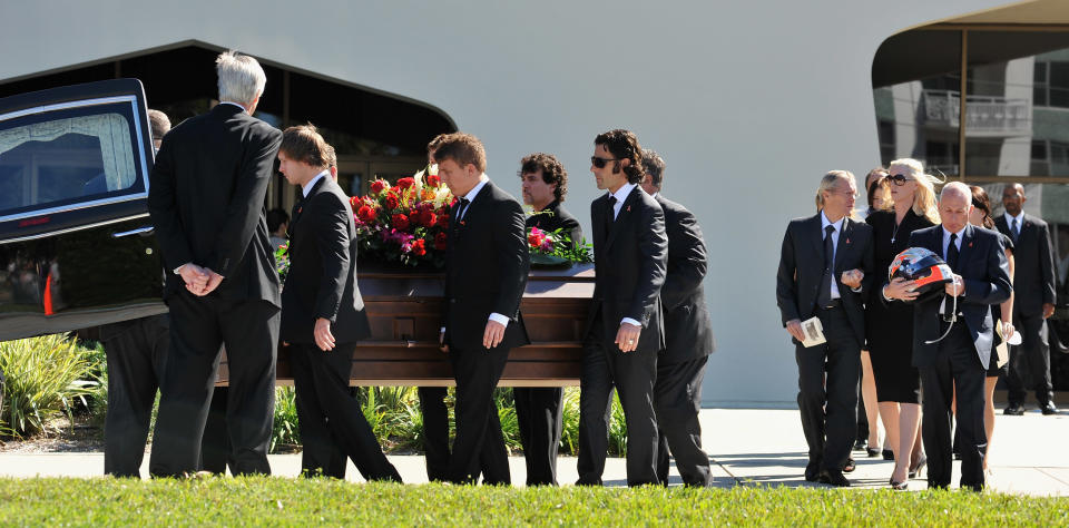 ST PETERSBURG, FL - OCTOBER 22: Dan Wheldon's widow Susie Wheldon (2nd R), his father Clive (R) and her father Sven Behm (3rdR) look on as Wheldon's casket is loaded into a hearse on October 22, 2011 in St Petersburg, Florida. Wheldon, who was 33 was killed in a 15-car crash at Sunday’s season-ending IndyCar race in Las Vegas. (Photo by Tim Boyles/Getty Images)