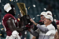 Alabama head coach Nick Saban and offensive lineman Alex Leatherwood hold the trophy after their win against Ohio State in an NCAA College Football Playoff national championship game, Tuesday, Jan. 12, 2021, in Miami Gardens, Fla. Alabama won 52-24. (AP Photo/Chris O'Meara)