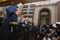 New York Mayor Bill de Blasio, left, Fire Commissioner Daniel Nigro, second left, and Police Commissioner James O'Neill, third left, participate in a press conference about a helicopter that crashed into the Equitable Building, at right, in New York, Monday, June 10, 2019. The Fire Department says the helicopter crash-landed on the top of the tower, which isn't far from Rockefeller Center and Times Square. (AP Photo/Richard Drew)