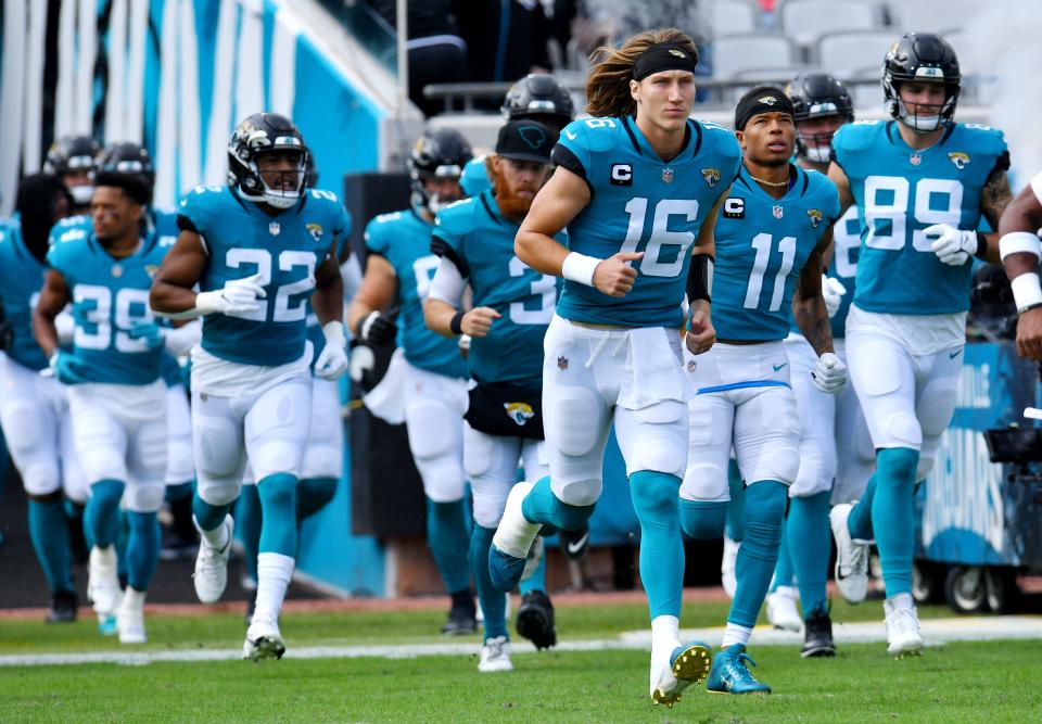 Jaguars quarterback Trevor Lawrence (16) runs onto the field with teammates before the start of the Nov. 7 game against the Bills.