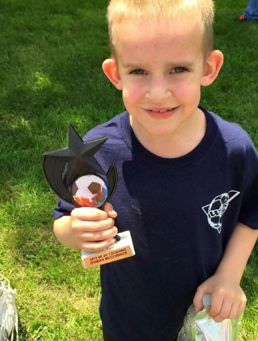 Roman McCormick is shown with a soccer award at age 8. Today, health problems prevent Roman from playing sports.