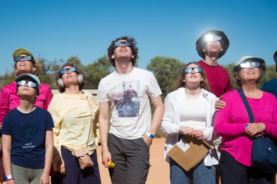 People wear protective glasses as they look up at a solar eclipse in Exmouth, Australia (AP)